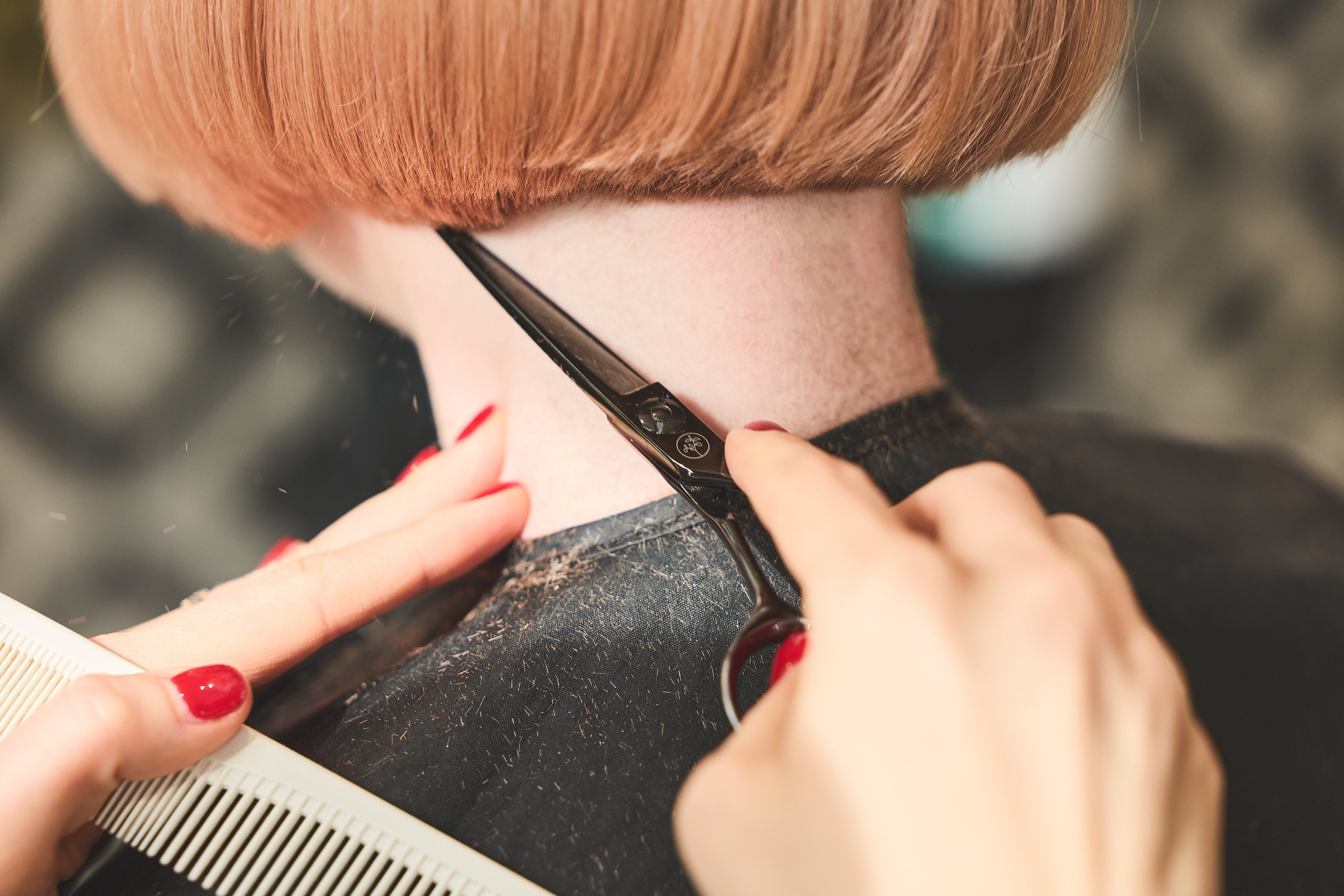 Hairdresser using Leaf scissors to create a precise salon cut