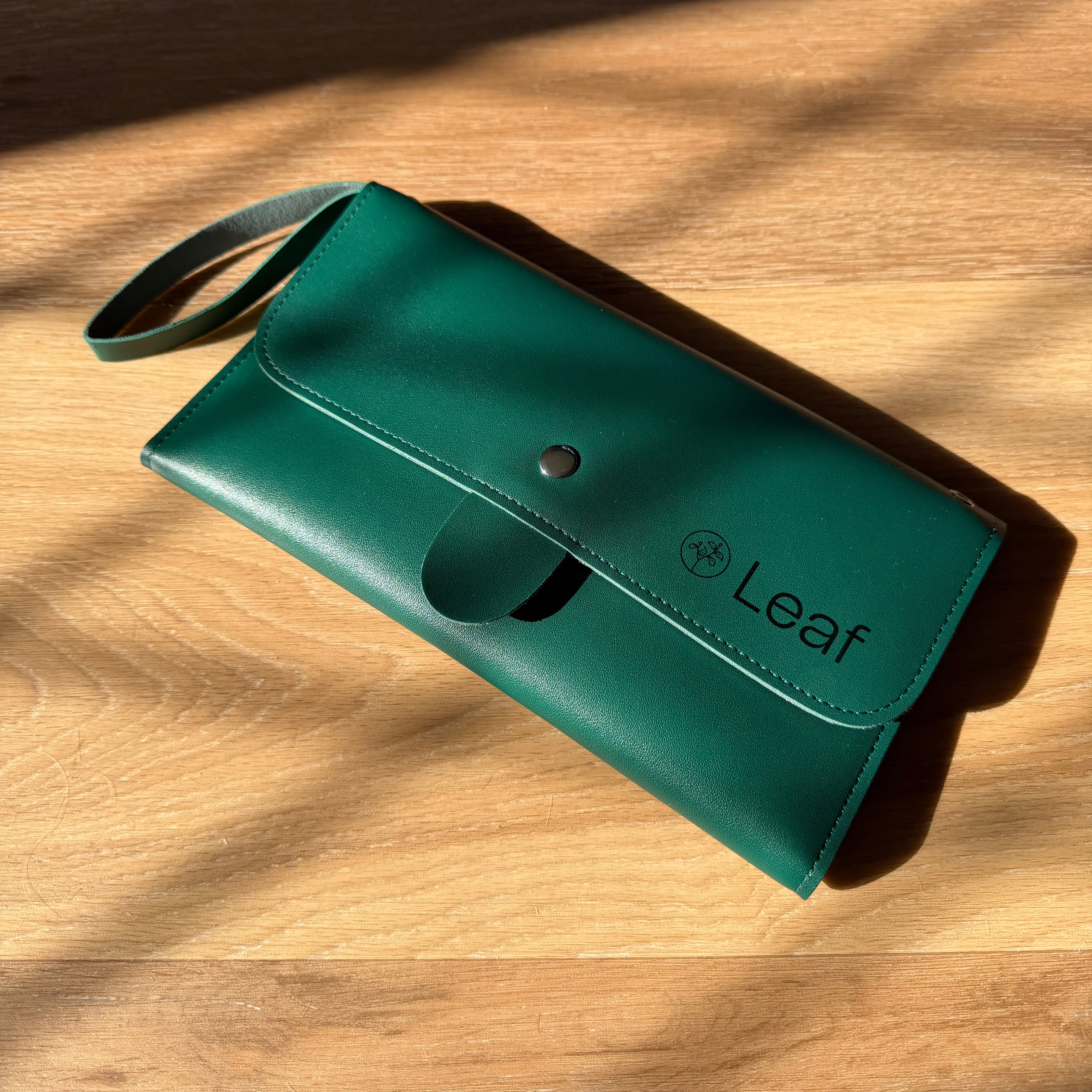 Green scissor case with 'Leaf' branding on a wooden surface