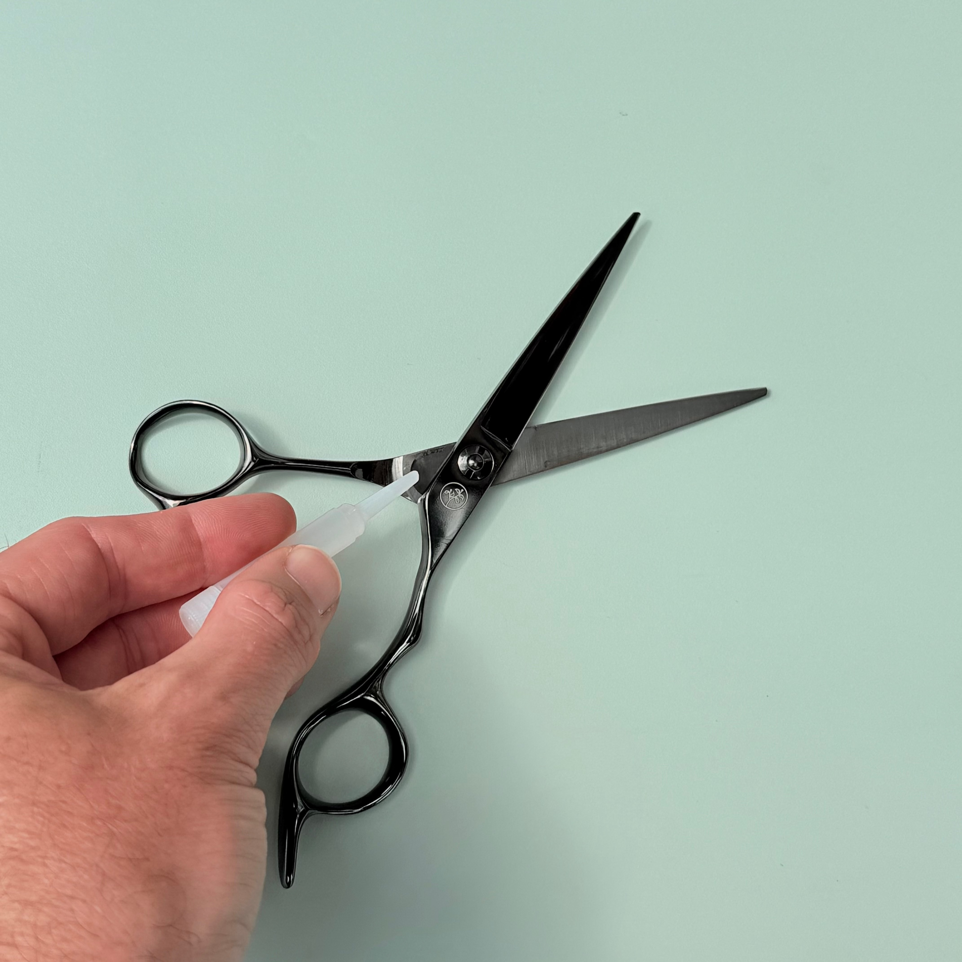 Scissor oil being applied to Leaf Scissors