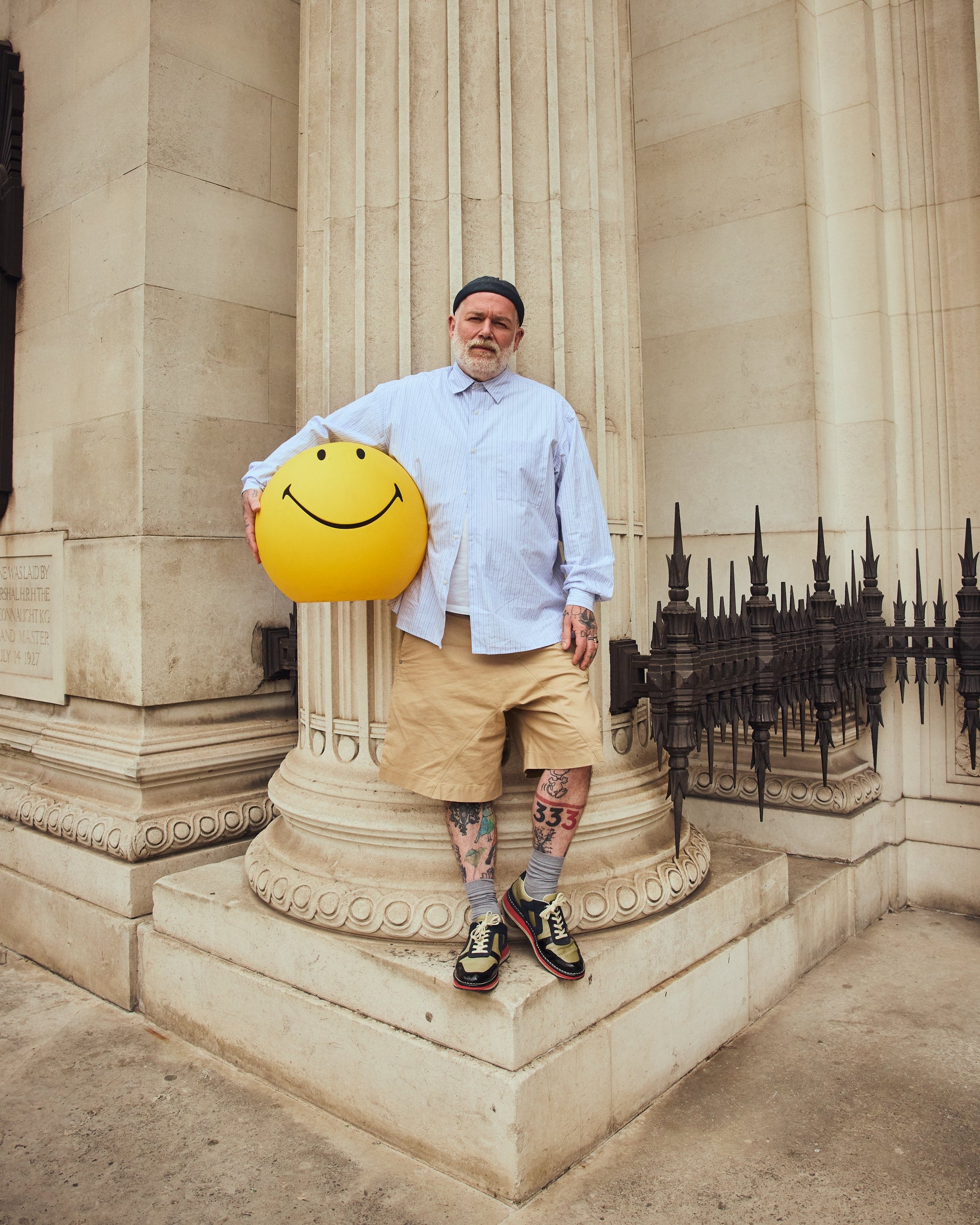 Adam Reed holding a yellow smiley face prop in the Yellow Edition campaign