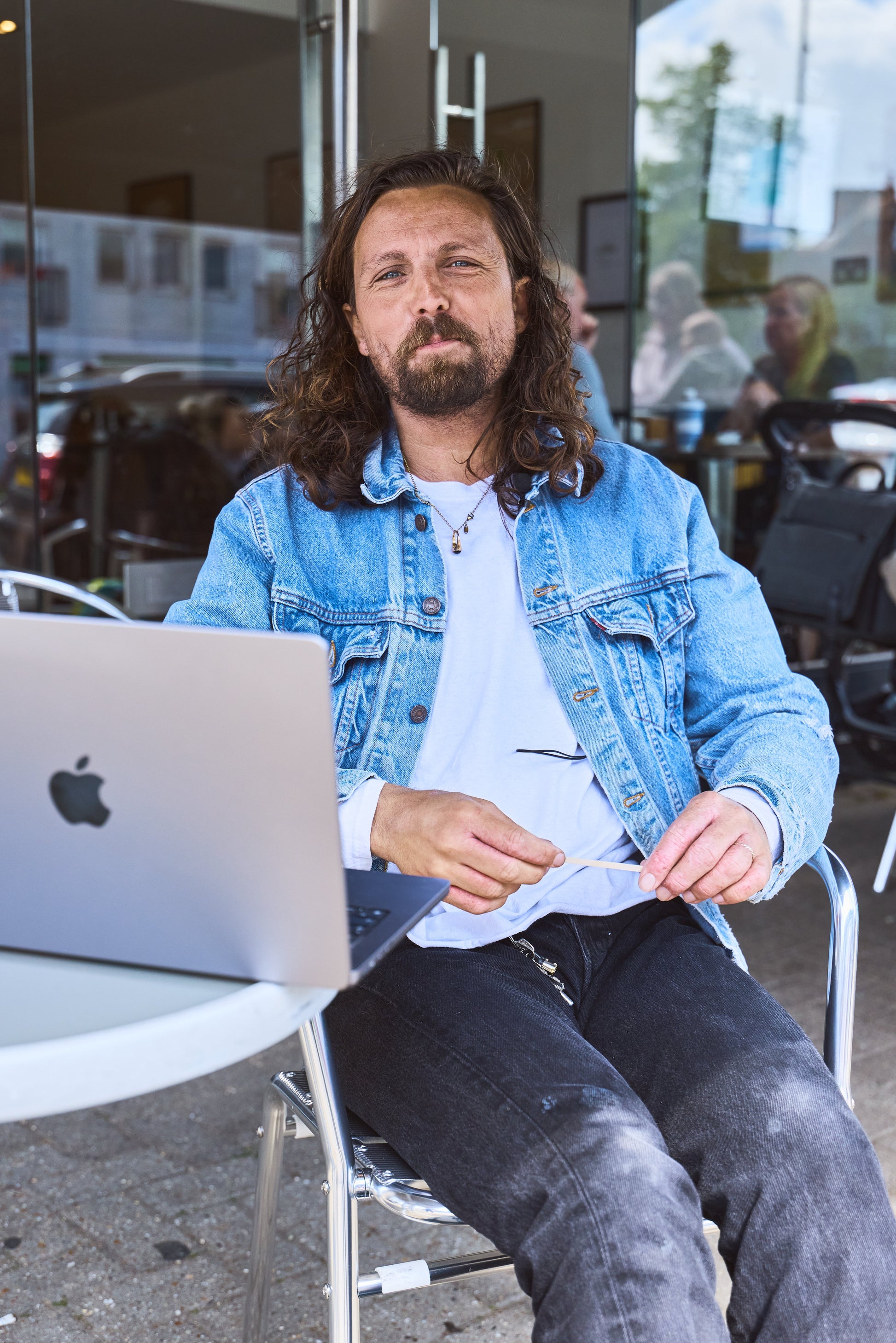 James Busby, hairdresser and content coach, seated with his laptop